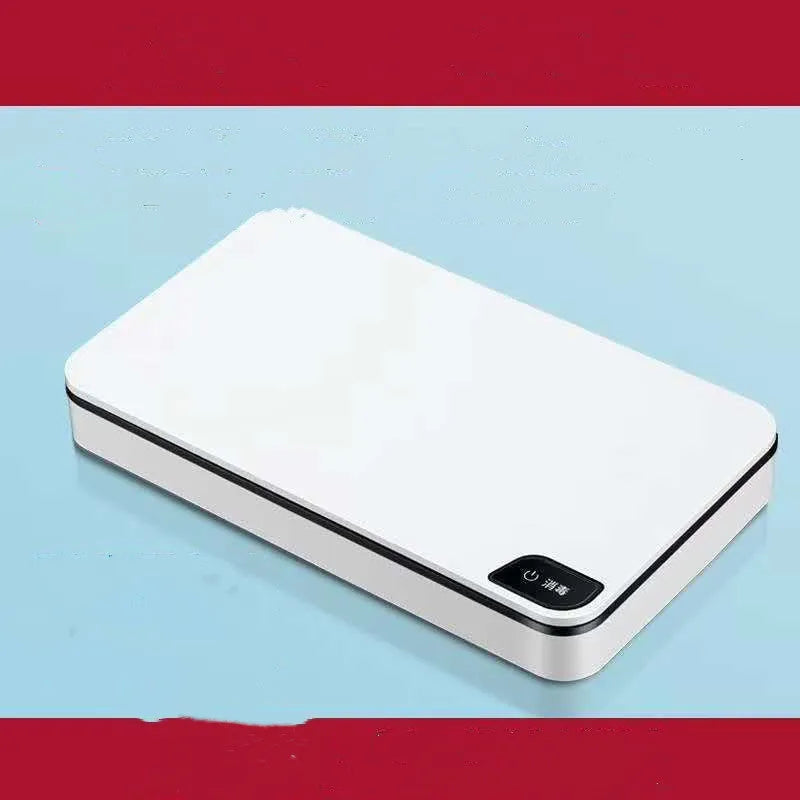 White multifunctional wireless charger with UV sterilisation and remote control on table