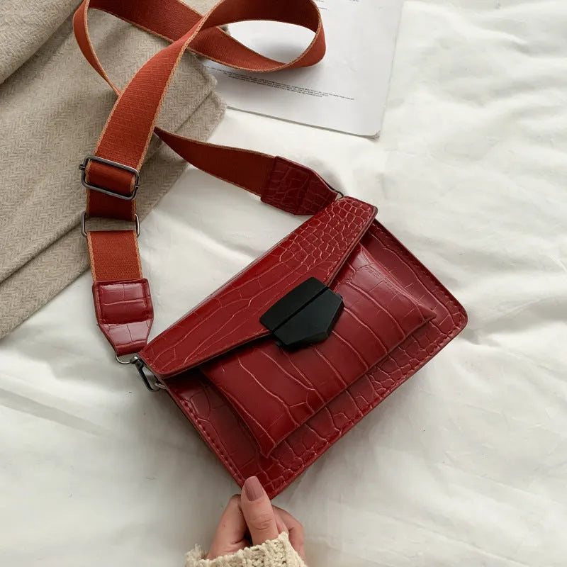 Vintage PU leather crossbody bag in black, shown with a mobile phone and wallet inside