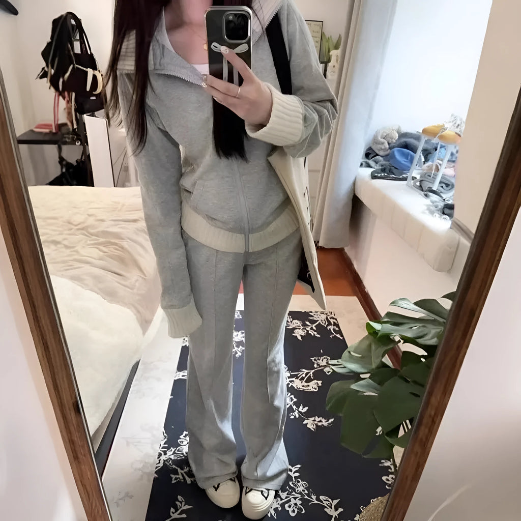 Light gray women's coat and wide leg trousers two-piece set with pockets on a plain background