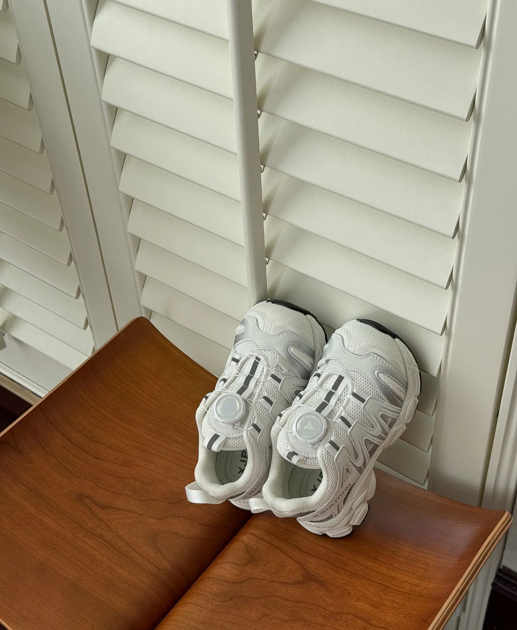 Girls solid colour casual slip-on sneakers in beige, made from lightweight PU leather mesh.