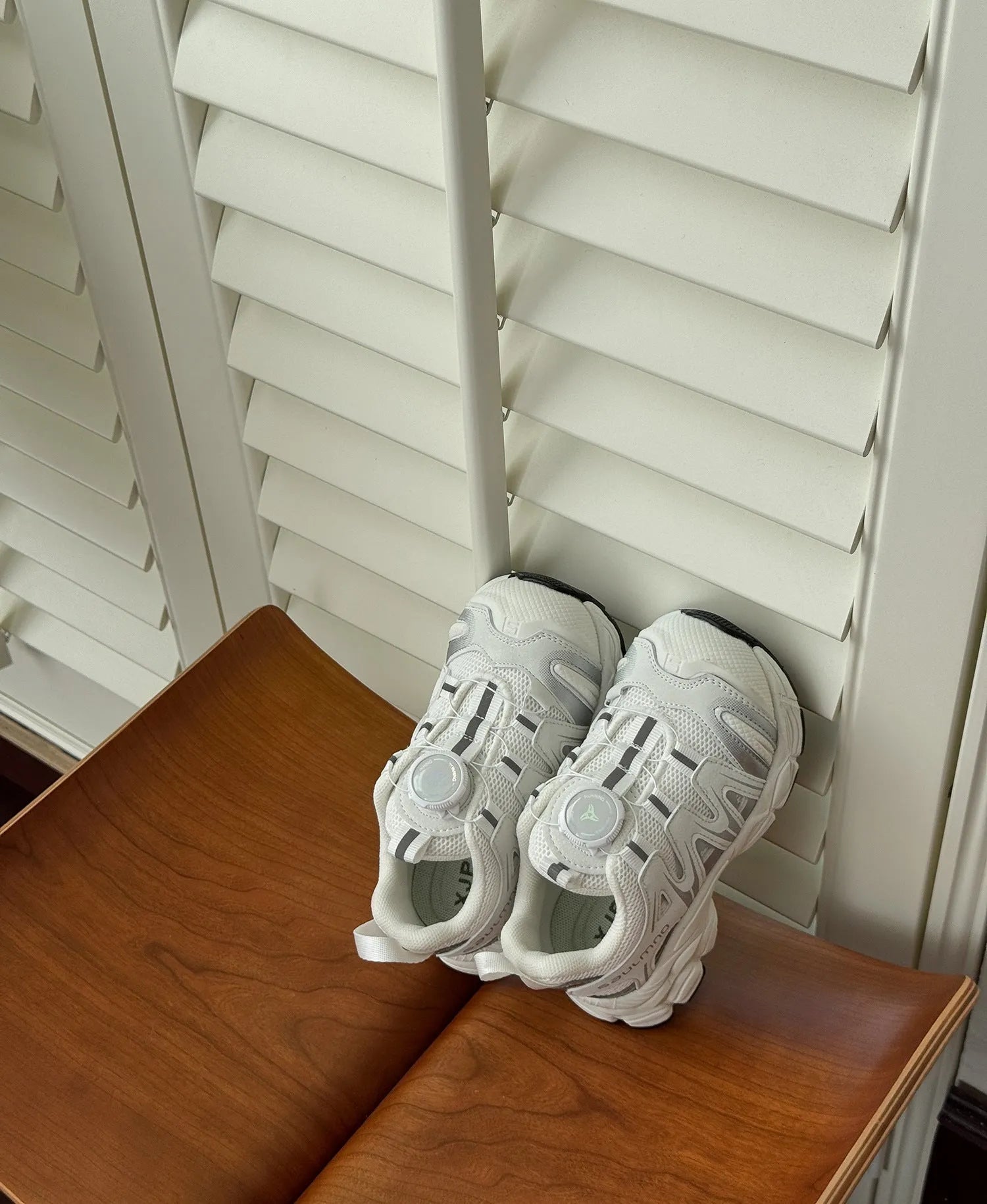 Girls solid colour casual slip-on sneakers in beige, made from lightweight PU leather mesh.