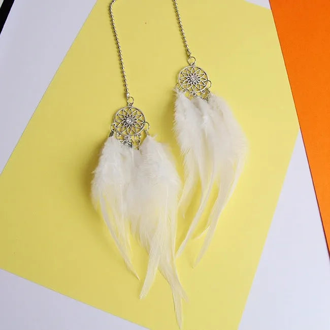 Dreamcatcher car ornament with metal frame and feather in one of six colours on car interior