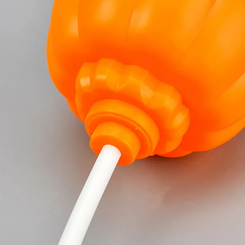 Plastic pumpkin-shaped lamp glowing with either purple or yellow light, measuring 22cm tall.
