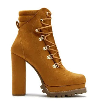 Women's yellow suede high heel ankle boots with round toe, platform, and rivet details