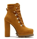 Women's yellow suede high heel ankle boots with round toe, platform, and rivet details