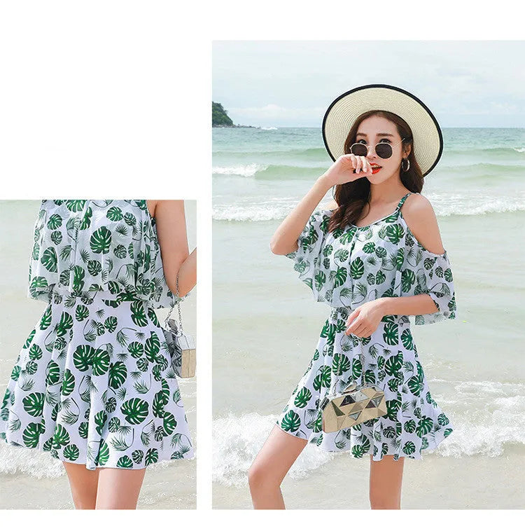 Women's green leaf style printed one-piece swimsuit laid flat.