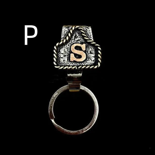 Handmade metal cow tag style key holder shown in one of its 26 colour options, attached to a keyring.