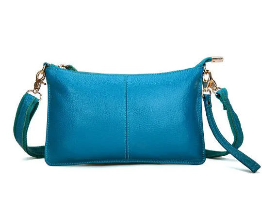 Lady's cowhide leather slant bag in apricot colour with hand strap and shoulder strap showing zipper compartments