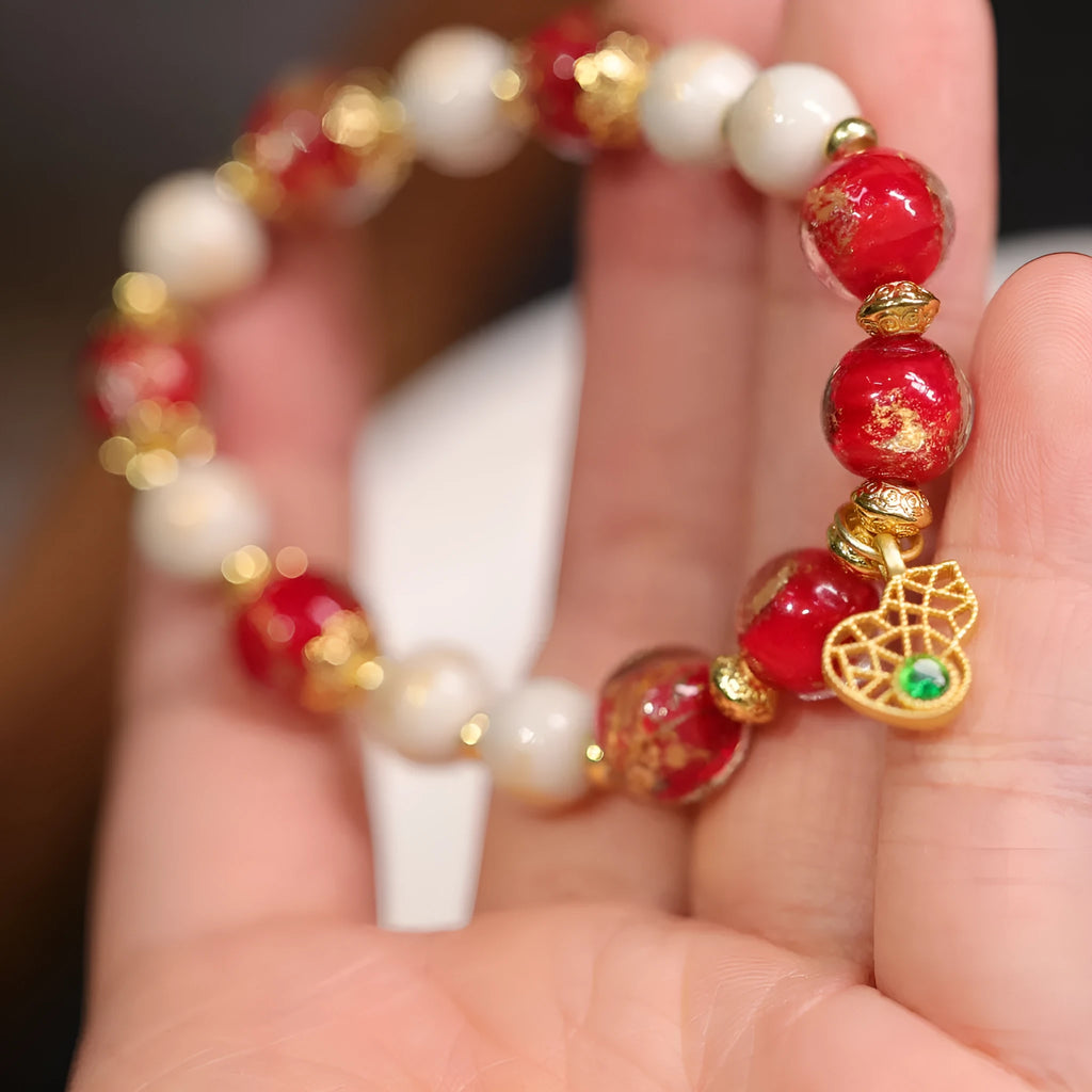 Women's handmade coloured glaze bracelet with gold foil decoration in geometric ethnic style design