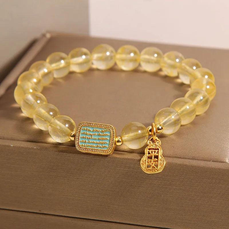Women's yellow citrine crystal bracelet with rhinestone decorations on wrist