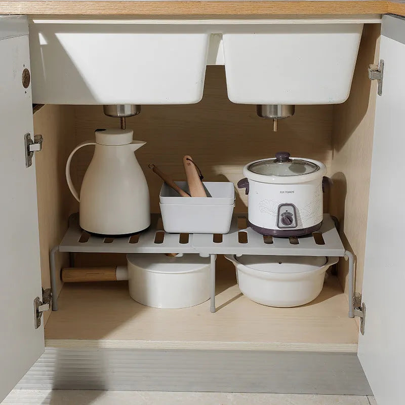 White telescopic kitchen rack with adjustable height showing extended and compressed positions