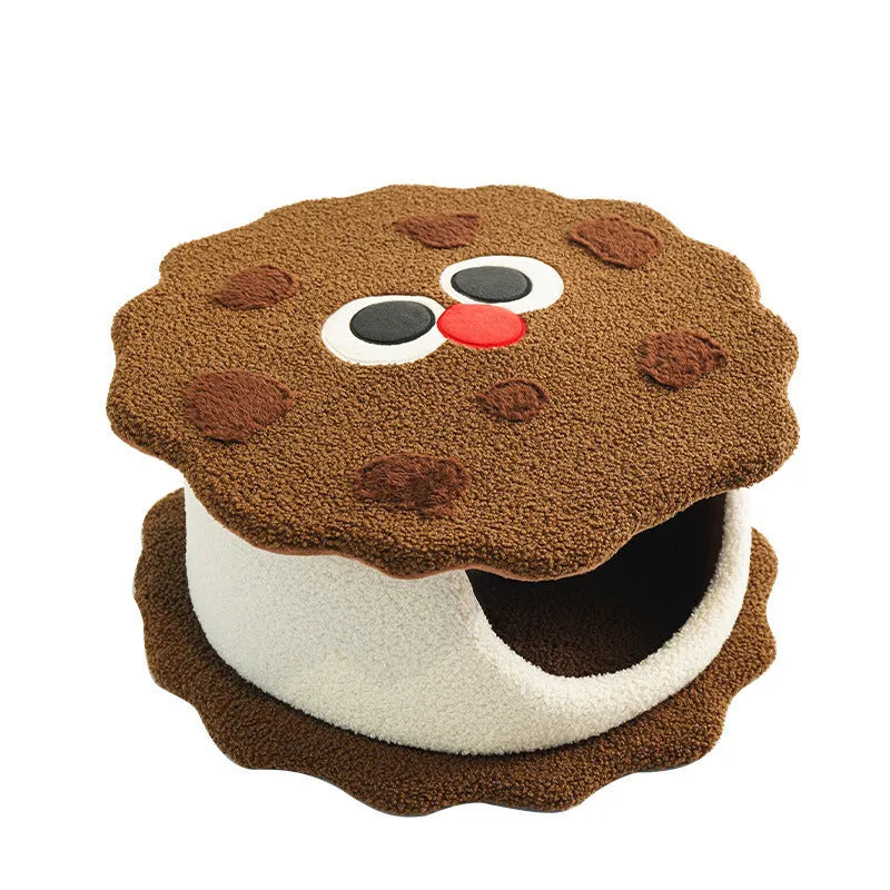 Khaki coloured enclosed cat nest shaped like a sandwich cookie for cold weather sleeping.