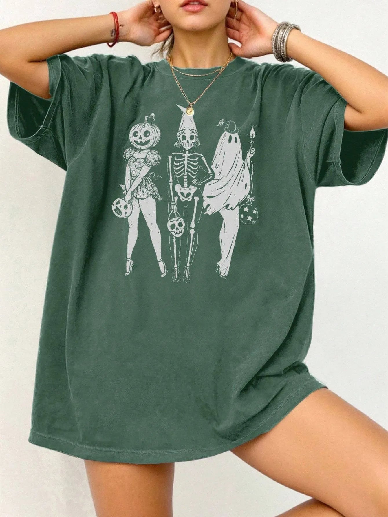 Loose short-sleeve cotton T-shirt on a hanger, showing round neckline, available in black, green, grey, and orange.
