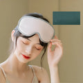 Portable eye spa massage goggles with suede exterior showing heat and vibration controls