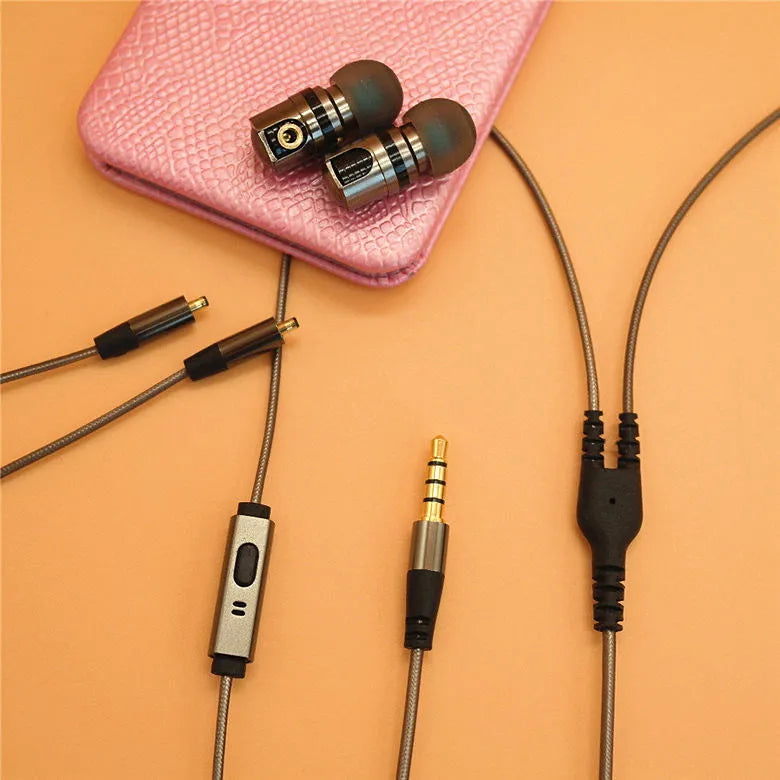 Titanium grey metal in-ear earphones with a detachable cable on a grey background.