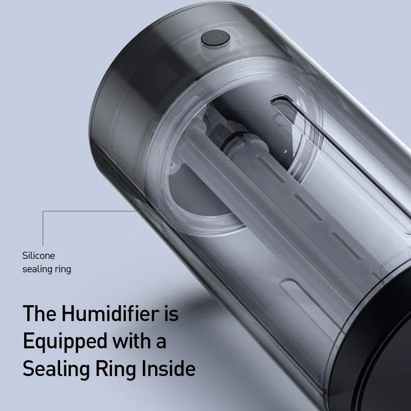 Black aluminium car humidifier and air purifier unit with USB cable on a car dashboard.