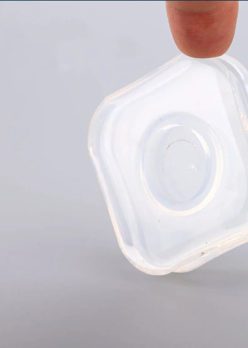 Transparent circular and square silicone nano gel adhesive pads on a smooth surface