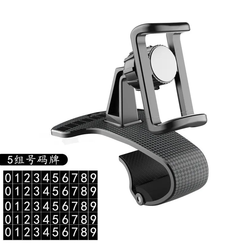 Black adjustable car phone holder with 360-degree rotating head on a car dashboard.