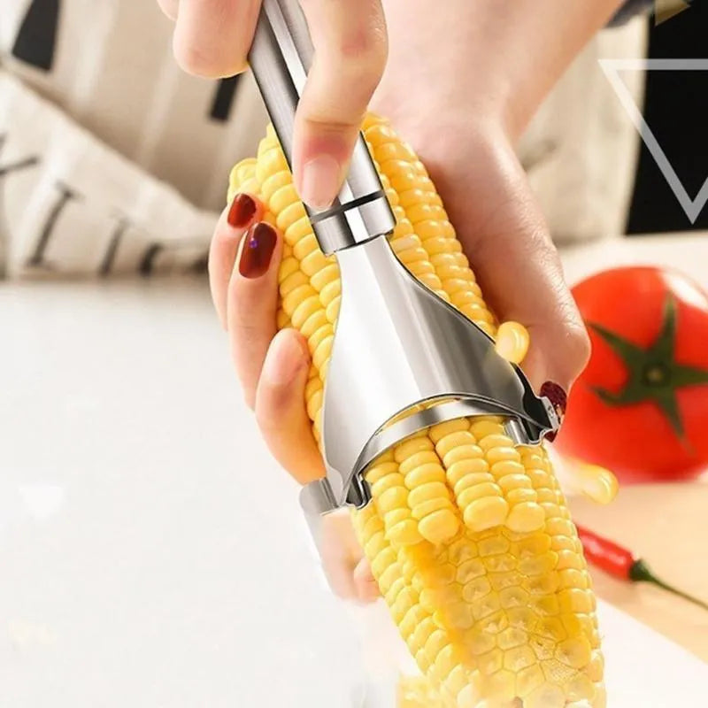 Stainless steel corn planer kitchen tool on a wooden surface