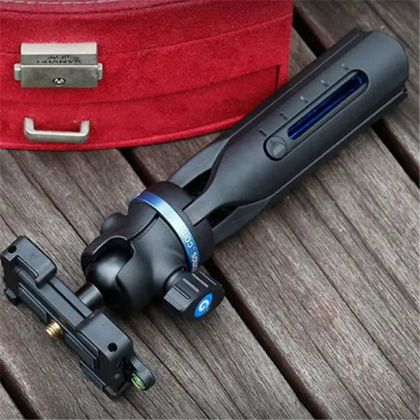 Black plastic and aluminium desktop tripod holding a mobile phone for video calls.