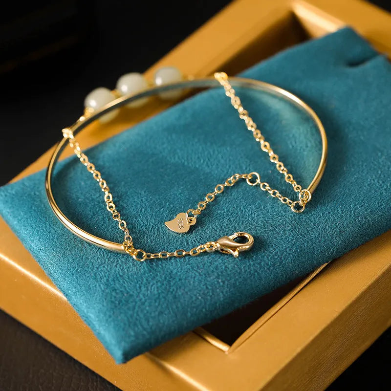 Women's jade lucky beads bracelet with gold inlay treatment in single, double, and three bead styles.
