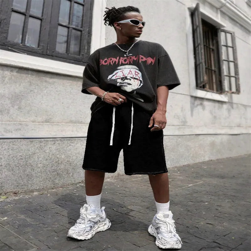 Men's straight leg polyester trousers in black, shown in a streetwear style pose.