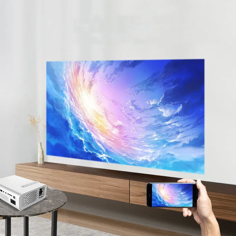 Portable HD 1080P projector in black with remote control and power cord on a table
