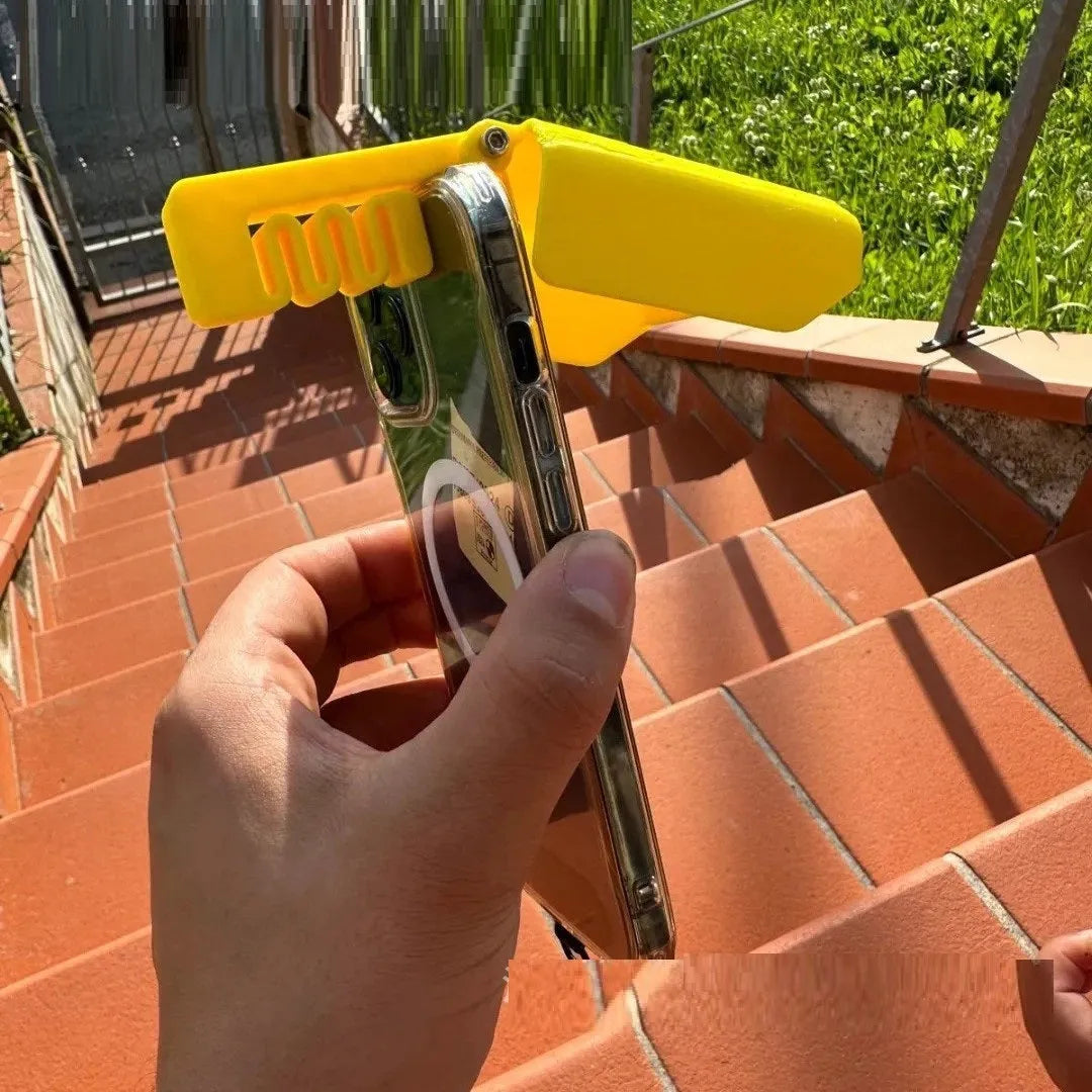 Yellow and black plastic beach phone sunshade holder with a clip for outdoor use.