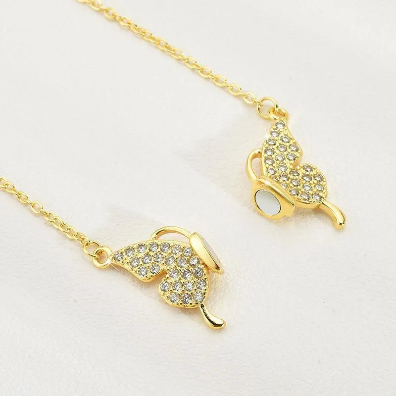 Gold titanium steel women's necklace with magnetic butterfly clasp and twisted chain.