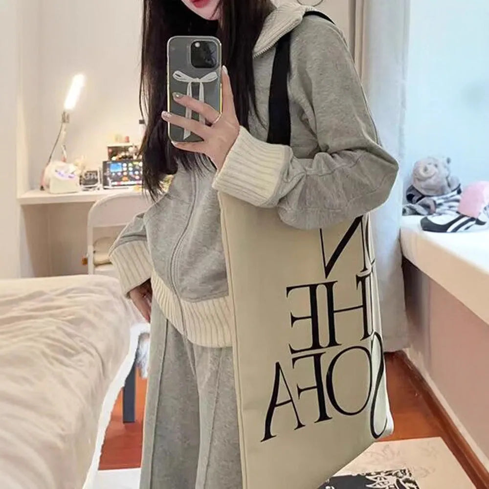 Light gray women's coat and wide leg trousers two-piece set with pockets on a plain background