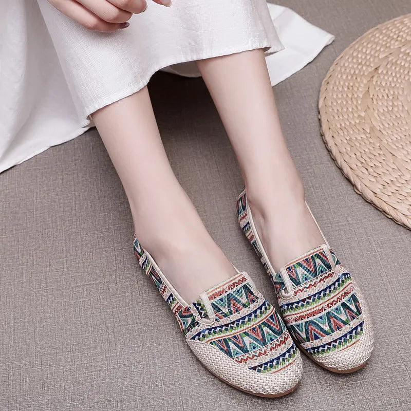 Women's flat heel ethnic cloth shoes in red, green, black, beige, or blue with colour stitching and a shallow mouth.
