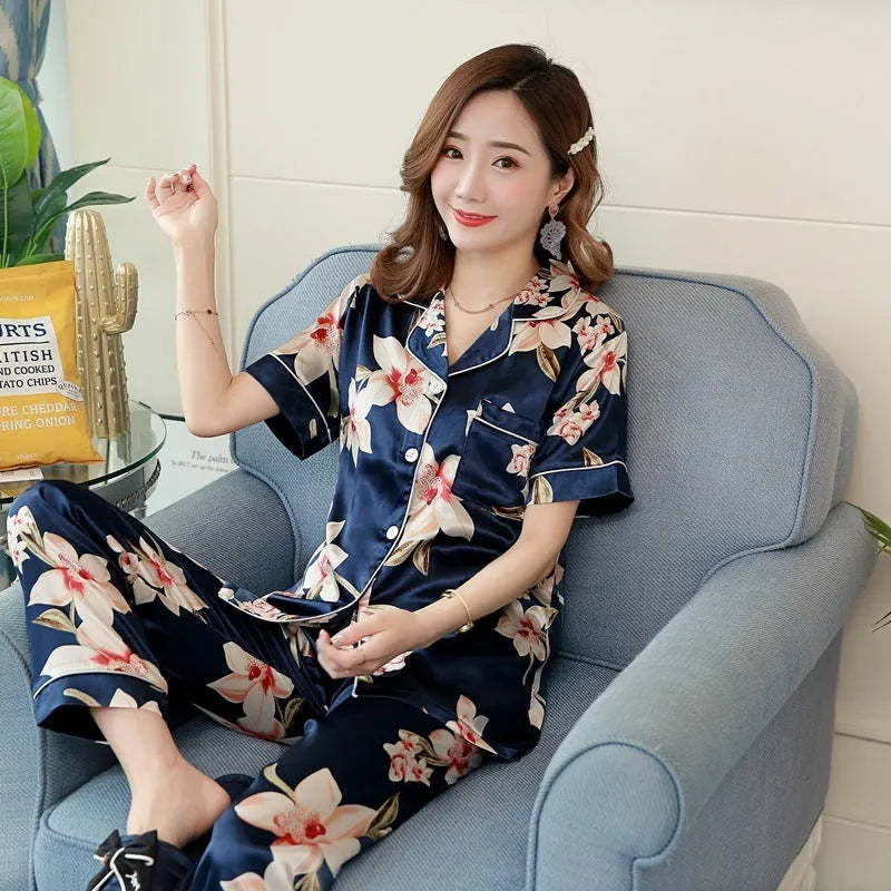 Women's two-piece short-sleeved pyjama set in begonia print with trousers, shown on a model