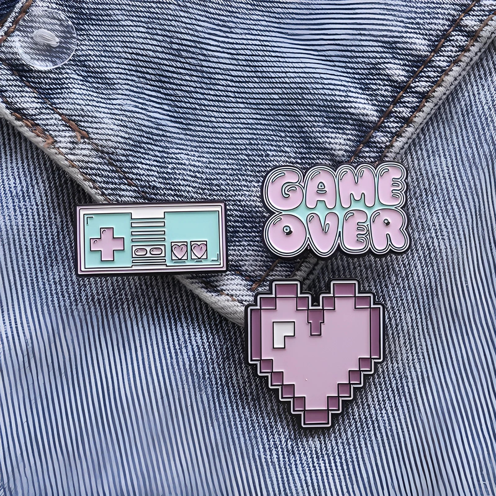 Stereo game console metal alloy badge with pin back, shown in available colours on a backpack strap
