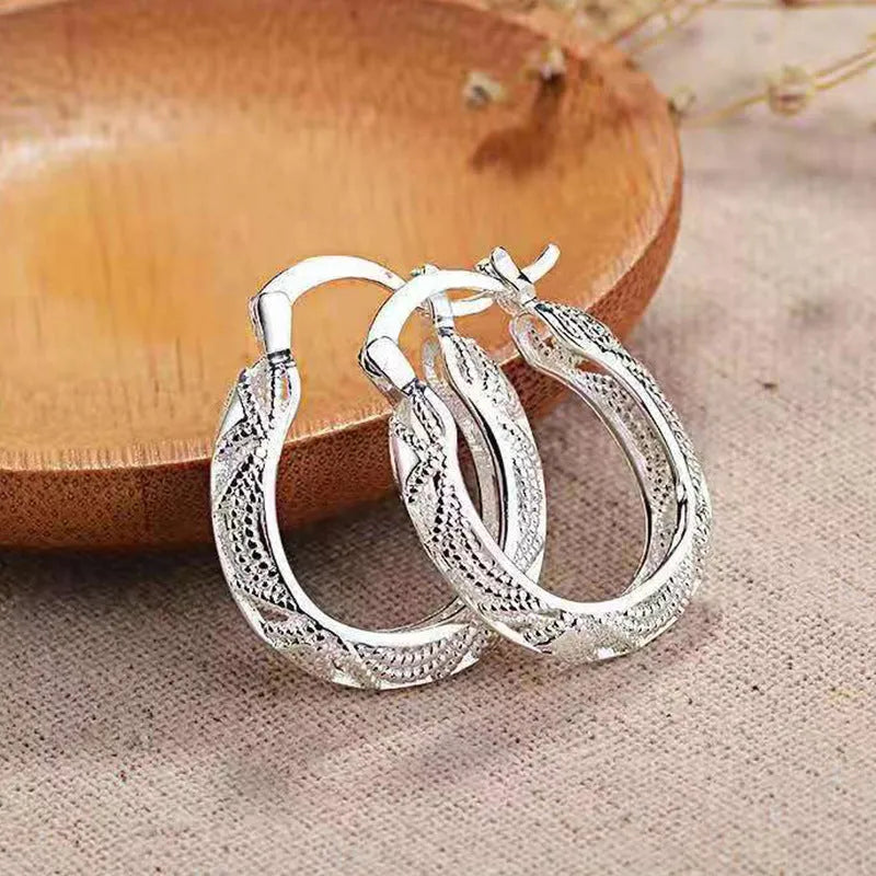 Geometric metal earrings for women with electroplated silver finish, individually packed.