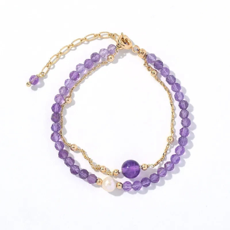 Close-up of an amethyst coloured Chinese style bracelet for women, featuring electroplated diamond-shaped crystals.