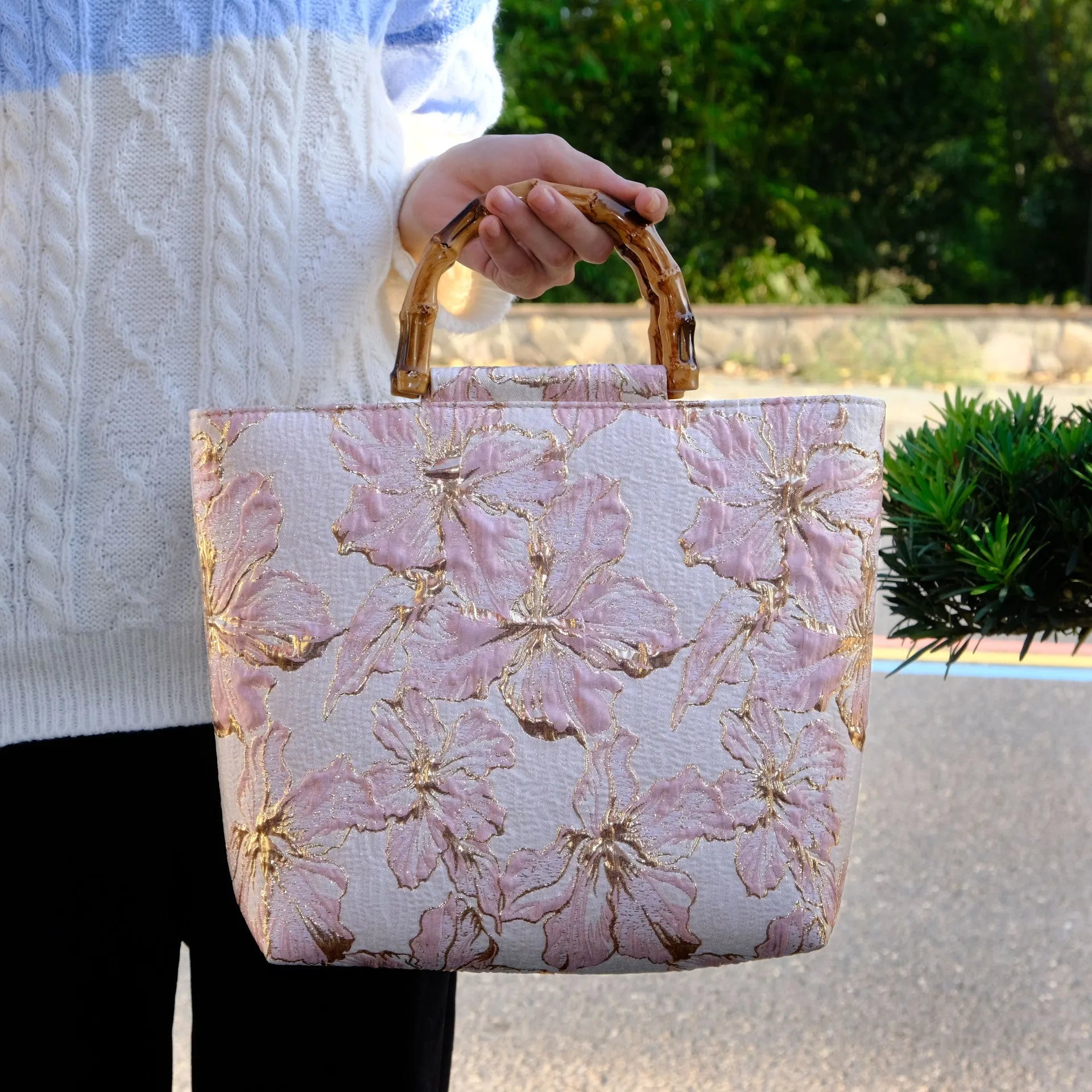 Women's light blue canvas shoulder bag with bronzing flower detail showing horizontal square shape and double straps