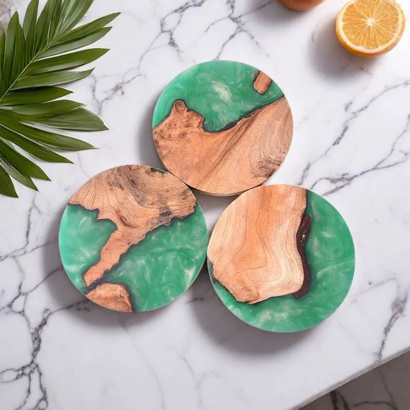 Wooden coaster with heat insulation resin in round tumour green colour on a table.