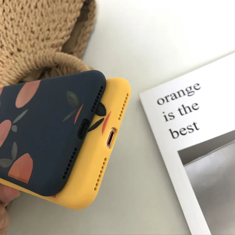 Orange matte finish TPU silicone case for iPhone on a table.