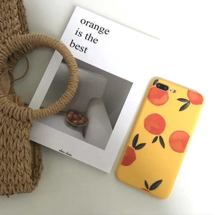 Orange matte finish TPU silicone case for iPhone on a table.