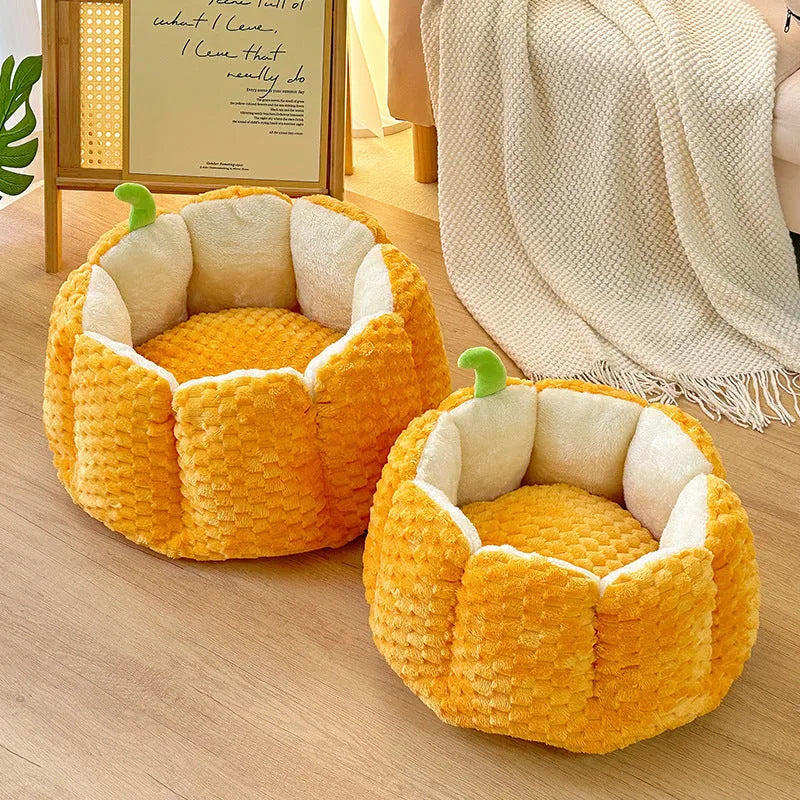 Orange pumpkin-shaped pet nest bed for cat or small dog with cotton filling.