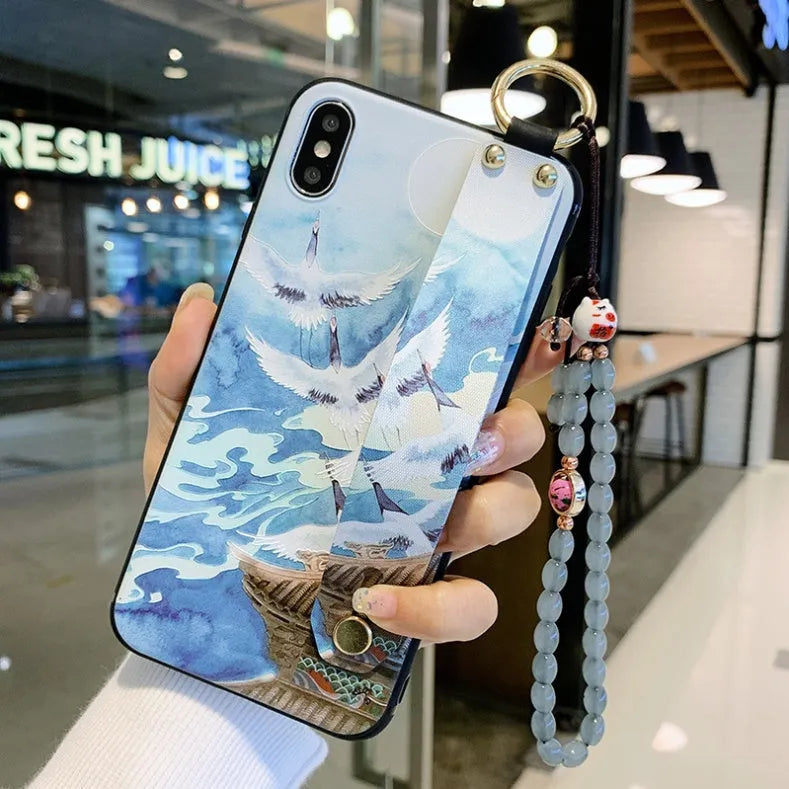 Rose flower design iPhone case with a white wrist strap attached, shown on an iPhone 11.