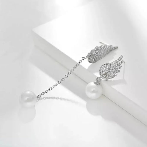 A pair of sterling silver angel wing earrings with diamond cut details and gold-plated gemstone inlay.