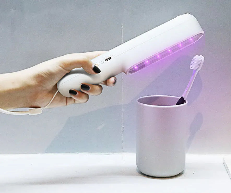 Portable UV sterilisation lamp hand-held 265nm wavelength 219mm long in pink and white colours