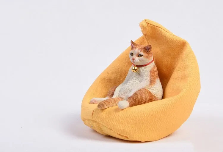 Small lazy cat model resting on a sofa, a resin car dashboard ornament decoration.