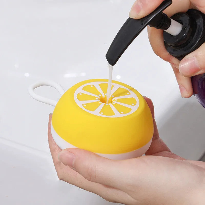 A soft silicone pet bath brush in yellow, shown with both a combed hair side and a 3D massage head side for dog and cat grooming.