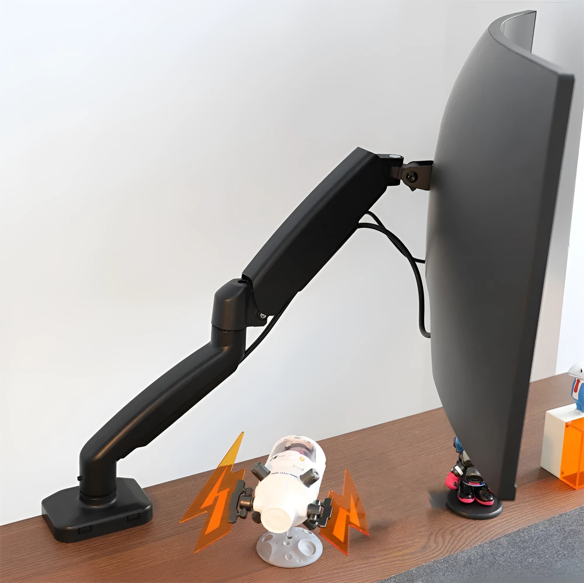 Black rotating telescopic monitor bracket on desk with adjustable arm and elevated design