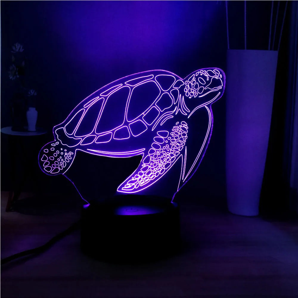 3D acrylic turtle-shaped LED night light with colour-changing illumination on a surface.