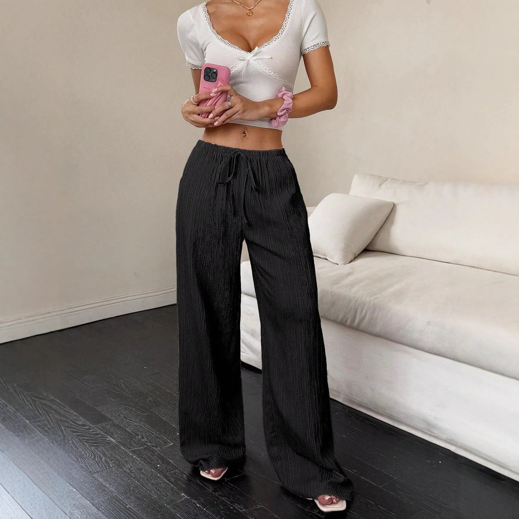 Women's black wide leg trousers with a front lace-up detail on the mid waist.