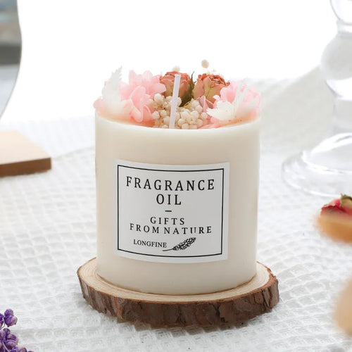 Aromatherapy candle with dried flowers on surface, shown in gift box with chip base.