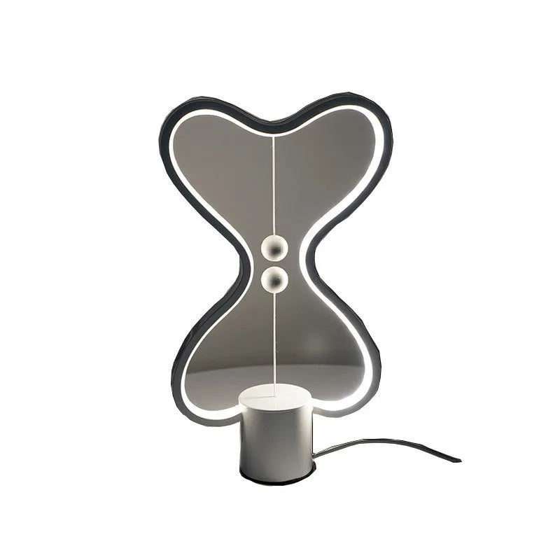 7-colour balance LED night light with magnetic suspension, USB powered, on a desk showing warm white glow